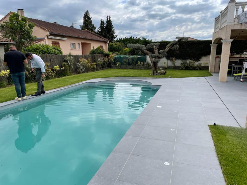 Rénovation d'une piscine et d'une terrasse carrelée à Roquettes. Intégration d'un caniveau invisible.